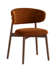 Laurel Orange Velvet Dining Chair with dark wood